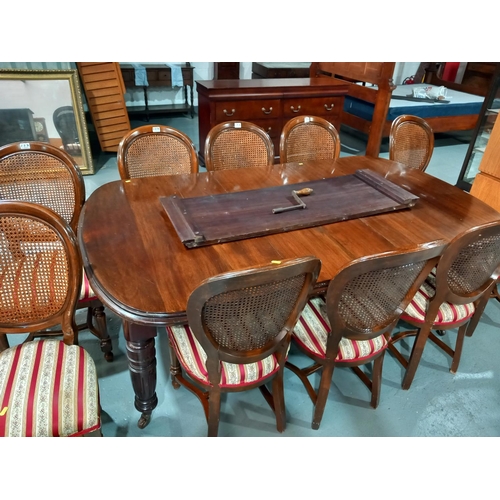 127 - A Victorian wind out mahogany extending dining table with two leaves, hand crank and 10 chairs