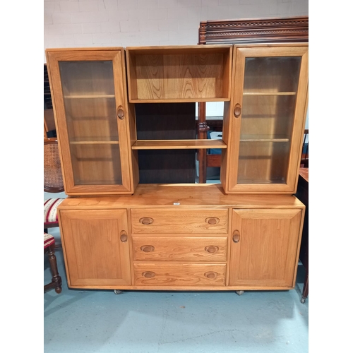 128 - An Ercol display cabinet on casters