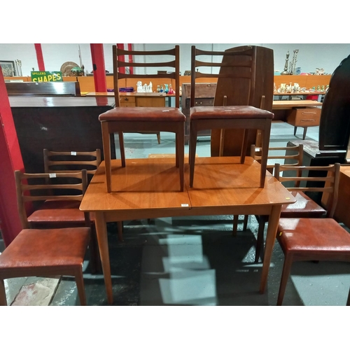 137 - A teak extending dining table and six chairs