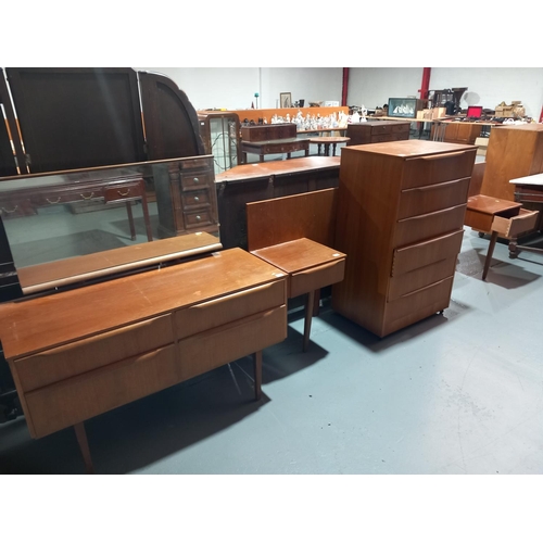 138 - A teak chest of drawers, dressing table and headboard