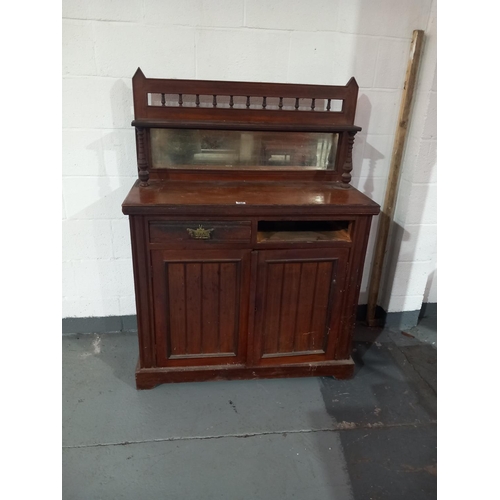 146 - An oak mirrored back sideboard (one drawer missing)