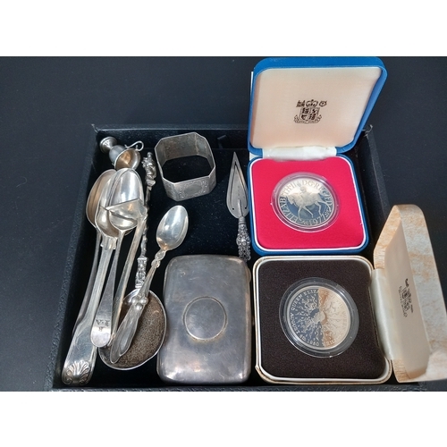 219 - Two silver Royal Mint Crowns (boxed) together with silver spoons, cigarette case, napkin rings etc (... 