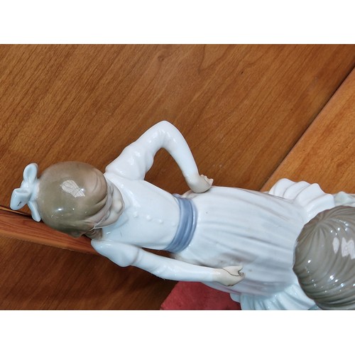 75 - A large collection of Nao and Lladro figurines - approximately 45 in total and other figurines