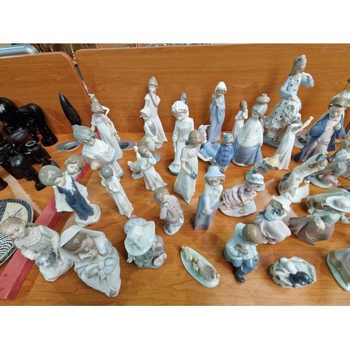 75 - A large collection of Nao and Lladro figurines - approximately 45 in total and other figurines