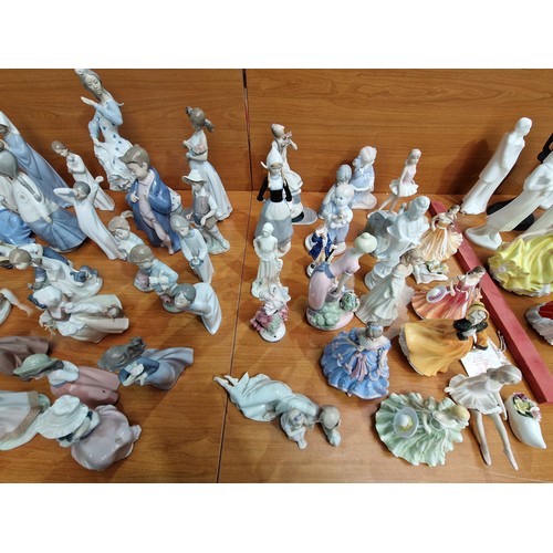 75 - A large collection of Nao and Lladro figurines - approximately 45 in total and other figurines