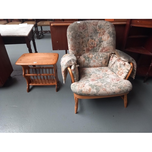 118 - An Ercol armchair (upholstery needs recovering) and an Ercol magazine rack