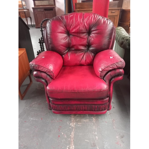 121 - A red leather Thomas Lloyd chesterfield armchair