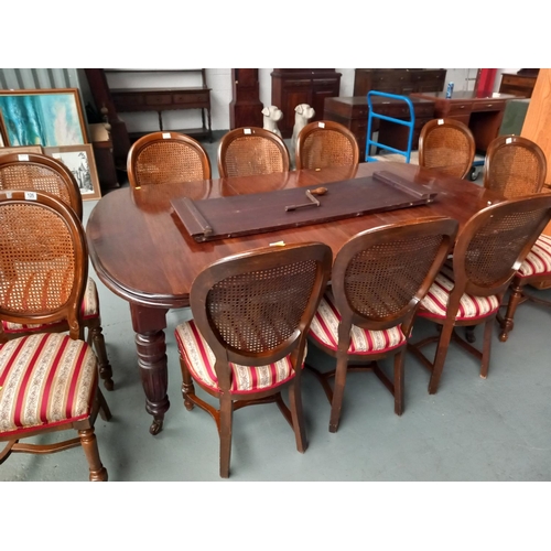 126 - A Victorian wind out mahogany extending dining table with two leaves, hand crank and 10 chairs