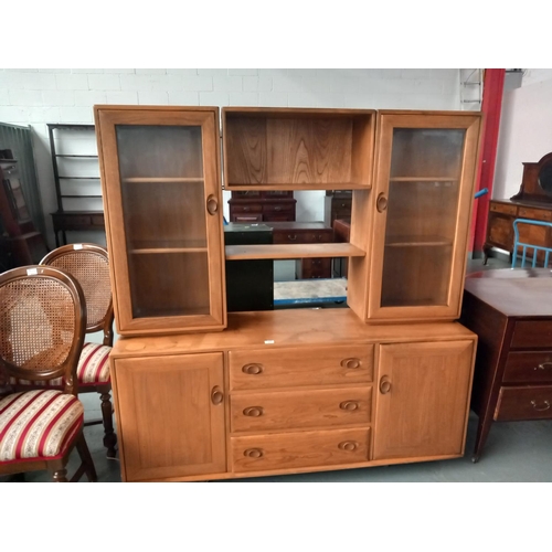 127 - An Ercol display cabinet on casters