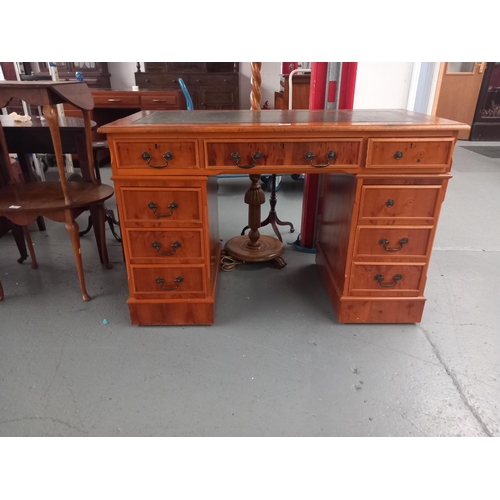 129 - A twin pedestal desk with leatherette insert