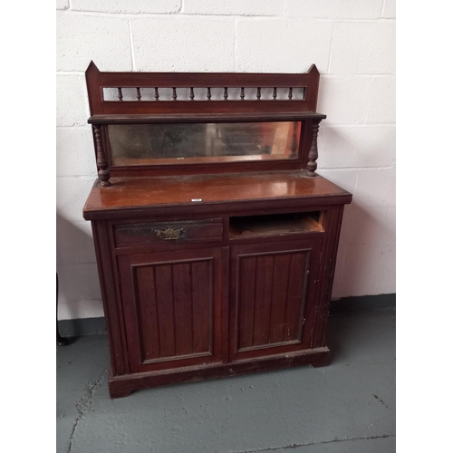 145 - An oak mirrored back sideboard (one drawer missing)