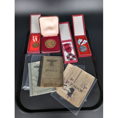 225 - A Polish Cross of Merit medal together with another Polish medal (both boxed), a boxed bronze medal,... 