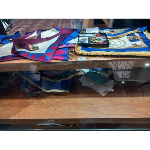 230 - A large collection of Masonic items - sashes, jewels, paperwork etc (two shelves)