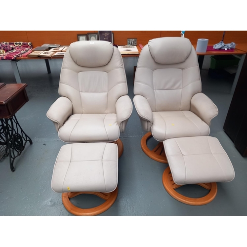 105 - Two cream leatherette reclining armchairs with stools