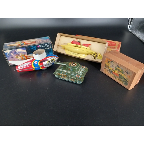 234 - Vintage tin plate toys - all boxed and in good condition - a friction driven tank and a torpedo boat... 