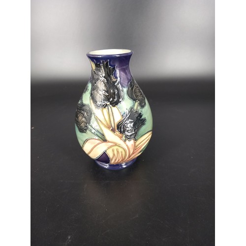 235 - A Moorcroft vase - Black Tulip pattern - impressed and painted marks to the base 8 inches high in go... 