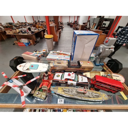 236 - A collection of vintage tin plate clockwork toys to include a Japanese K.O. vintage car with steerin... 