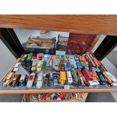 237 - A collection of playworn diecast model cars - Dinky, Corgi and others (displayed over two shelves)