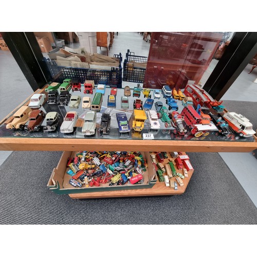 237 - A collection of playworn diecast model cars - Dinky, Corgi and others (displayed over two shelves)