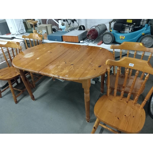 416 - A pine extending dining table and 4 pine chairs