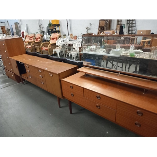 415 - A teak dressing table, a sideboard and a teak 6 drawer chest of drawers