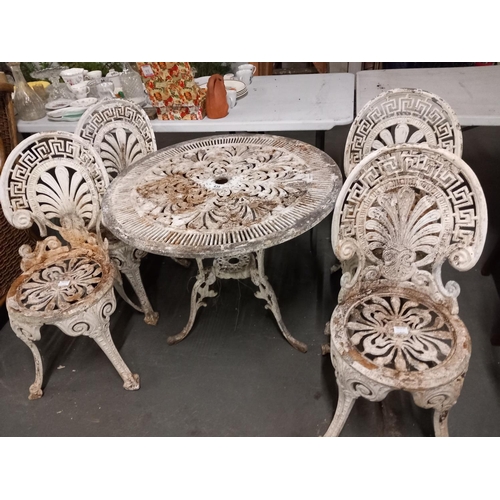 439 - A white cast iron garden table and four chairs