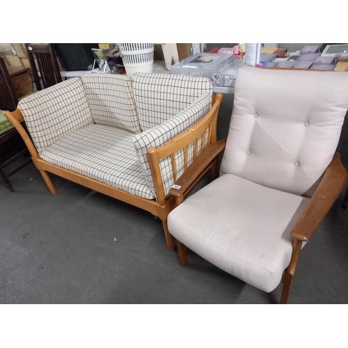 443 - A teak armchair and a pine effect two seater sofa