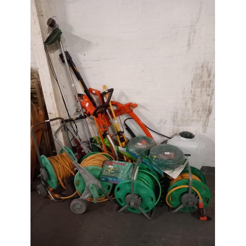 460 - Black and Decker strimmer, fly mower and four hose reels, electric hedgestrimmer etc