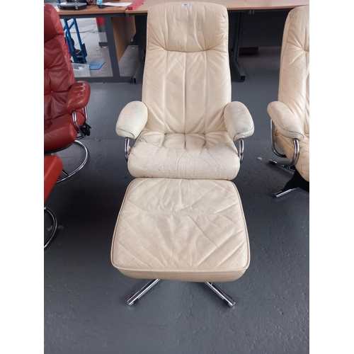 101 - A cream leather Skoghang reclining swivel armchair with stool