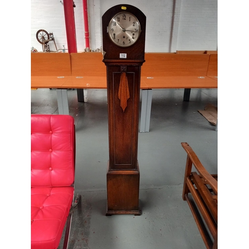 112 - An oak cased granddaughter clock