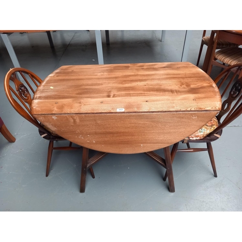 117 - An Ercol drop leaf dining table togther with two ercol fleur de llys dining chairs