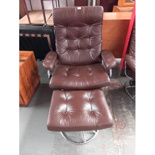 122 - A dark brown leather Ekornes reclining swivel armchair with stool