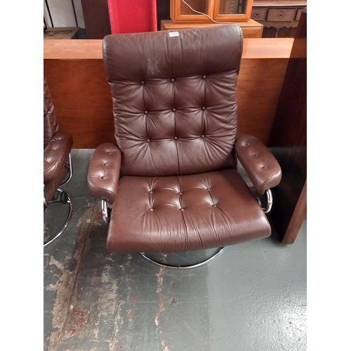 123 - A dark brown leather Ekornes reclining swivel armchair