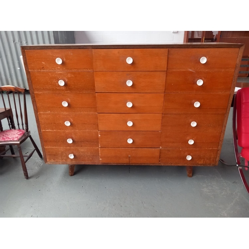 128 - A midcentury style teak fronted 18 drawer bank of drawers