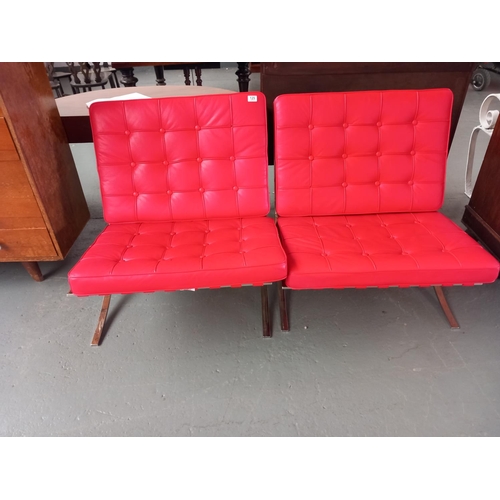 129 - Two red leather chrome framed barcelona style chairs