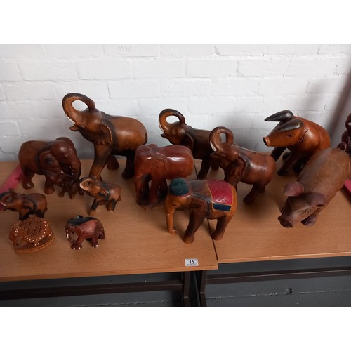 15 - Ten wooden carved elephants and two wooden carved pigs