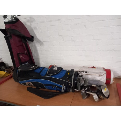 511 - Three sets of golf bags and clubs