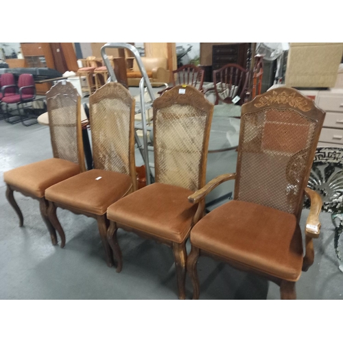 558 - Four fabric seated rattan backed dining chairs to include one carver