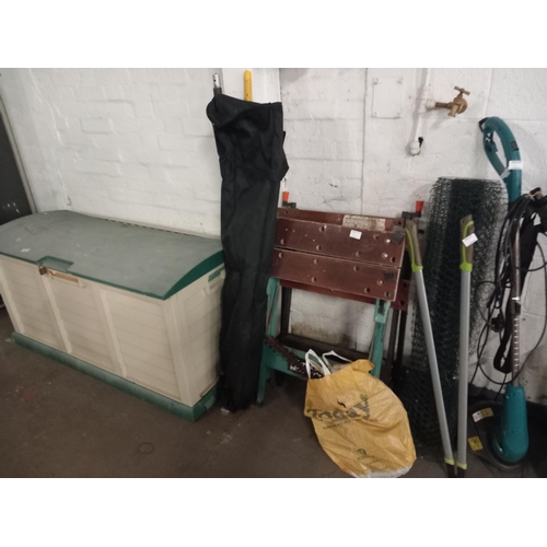 686 - A garden storage box, workmate, gardening tools etc