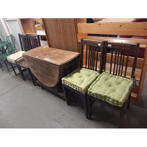 348 - An oak drop leaf dining table and four oak chairs