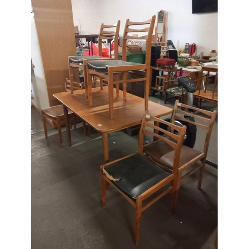 371 - A teak extending dining table and six chairs