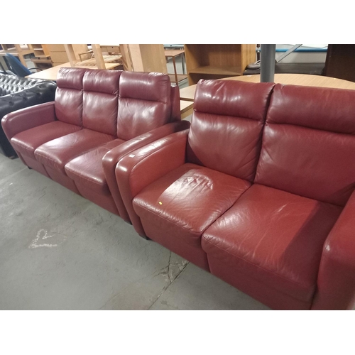 385 - A three seater and a two seater red leather sofa