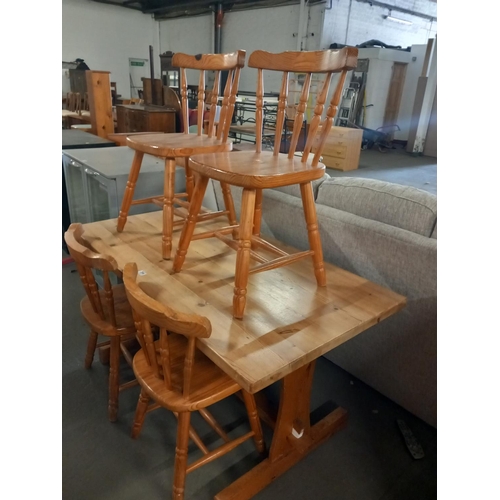 394 - A pine dining table and four chairs