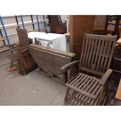 402 - A folding garden table and three chairs