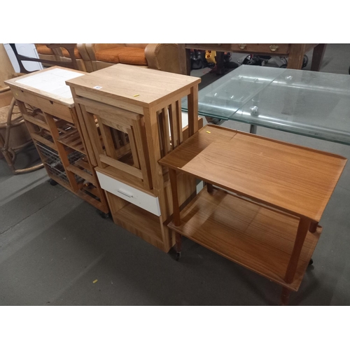 420 - A pine kitchen storage cabinet, nest of tables, drinks trolley etc