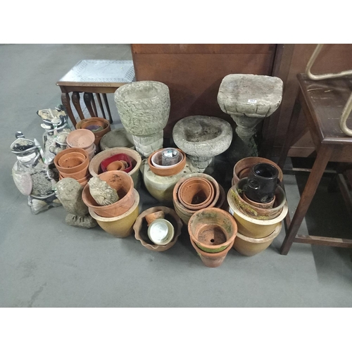 457 - A collection of stone and terracota planters and stone ornaments