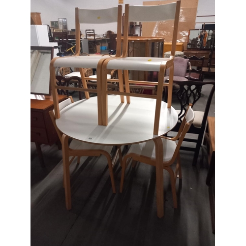 465 - A circular dining table and four chairs