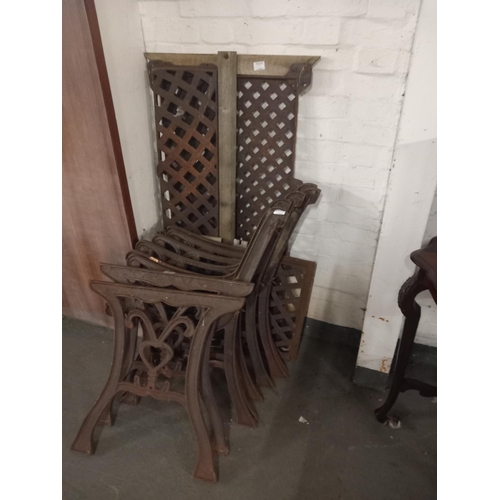 477 - Three cast iron bench ends and a cast iron table