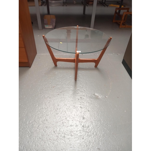 104 - A circular glass top mid century coffee table