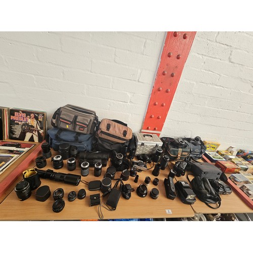 2 - A quantity of camera equipment - Nikon F50, Pentax ME Super, Canon AE1 and other cameras, a large qu... 